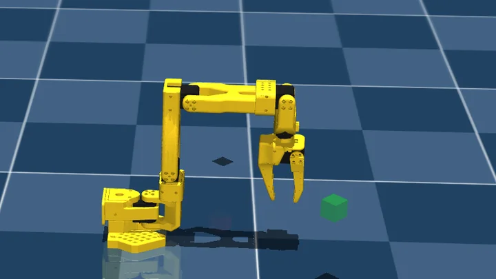 A MuJoCo simulation: a yellow six-axis robot arm with an open two-finger gripper poised above a green cube on a dark tiled floor